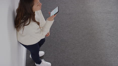 Overhead-Shot-Of-Stressed-Or-Anxious-Woman-Sitting-On-Floor-Leaning-Against-Wall-At-Home-Reacting-To-Internet-Or-Social-Media-News-Message-Or-Story-On-Mobile-Phone-3